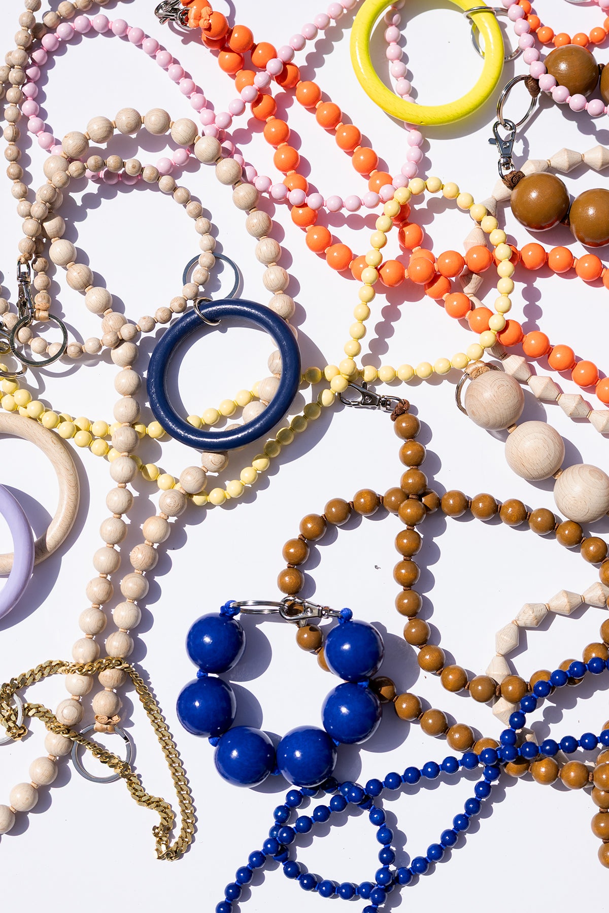 Colorful beaded bracelets and necklaces on a white background
