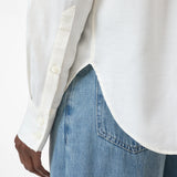 close up view of buttons on the sleeve on the oversized button up in white
