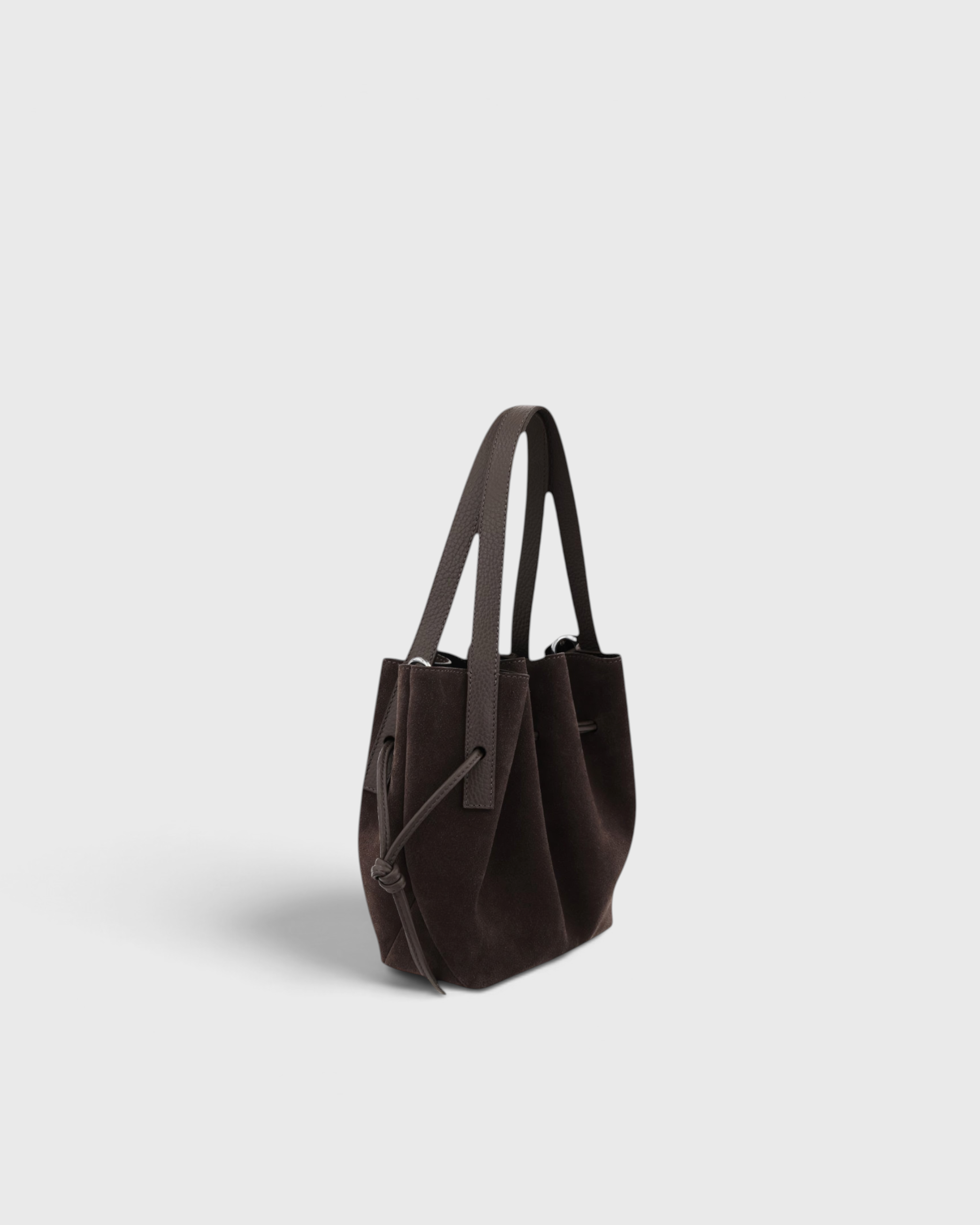 JONES + CO Mini Scallop Tote in ganache brown Italian suede with silver-tone hardware and sculptural top handles.