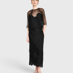 Model wearing JONES + CO black organza Bari top with delicate waterlily embroidery over a matching black slip dress.