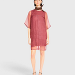 Model wearing a dark cerise JONES + CO Umbria organza dress with sheer short sleeves and a patterned neck scarf