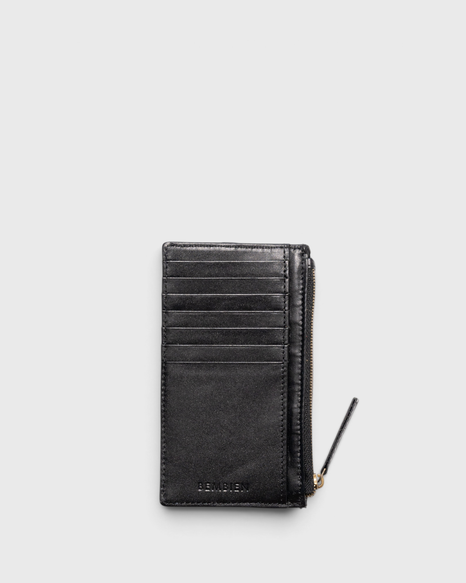 JONES + CO Odin black leather card case with seven slots and a side zip pouch for coins and bills.
