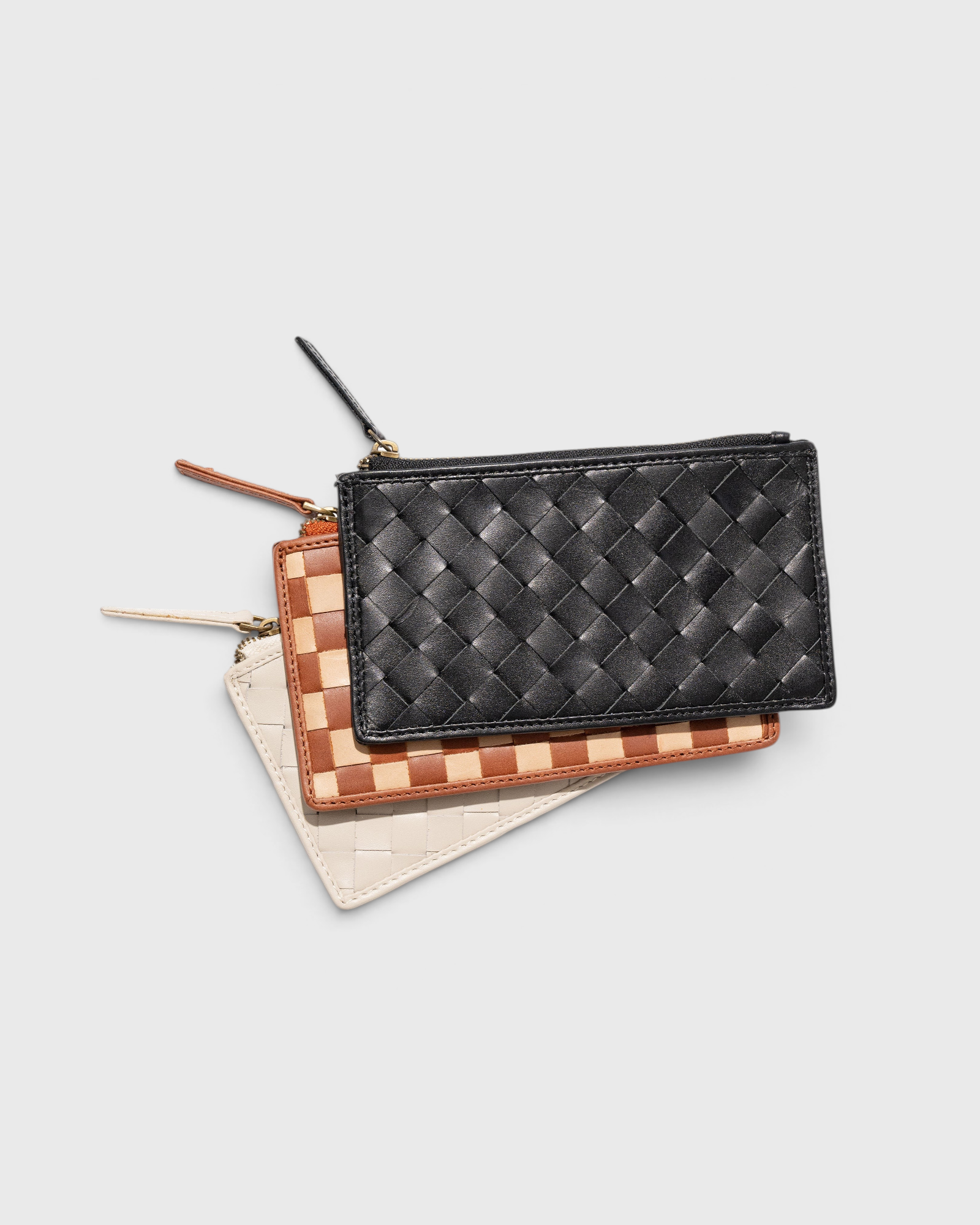 JONES + CO Odin card cases in black, tan, and white woven leather with zip pouches and minimalist slim design.