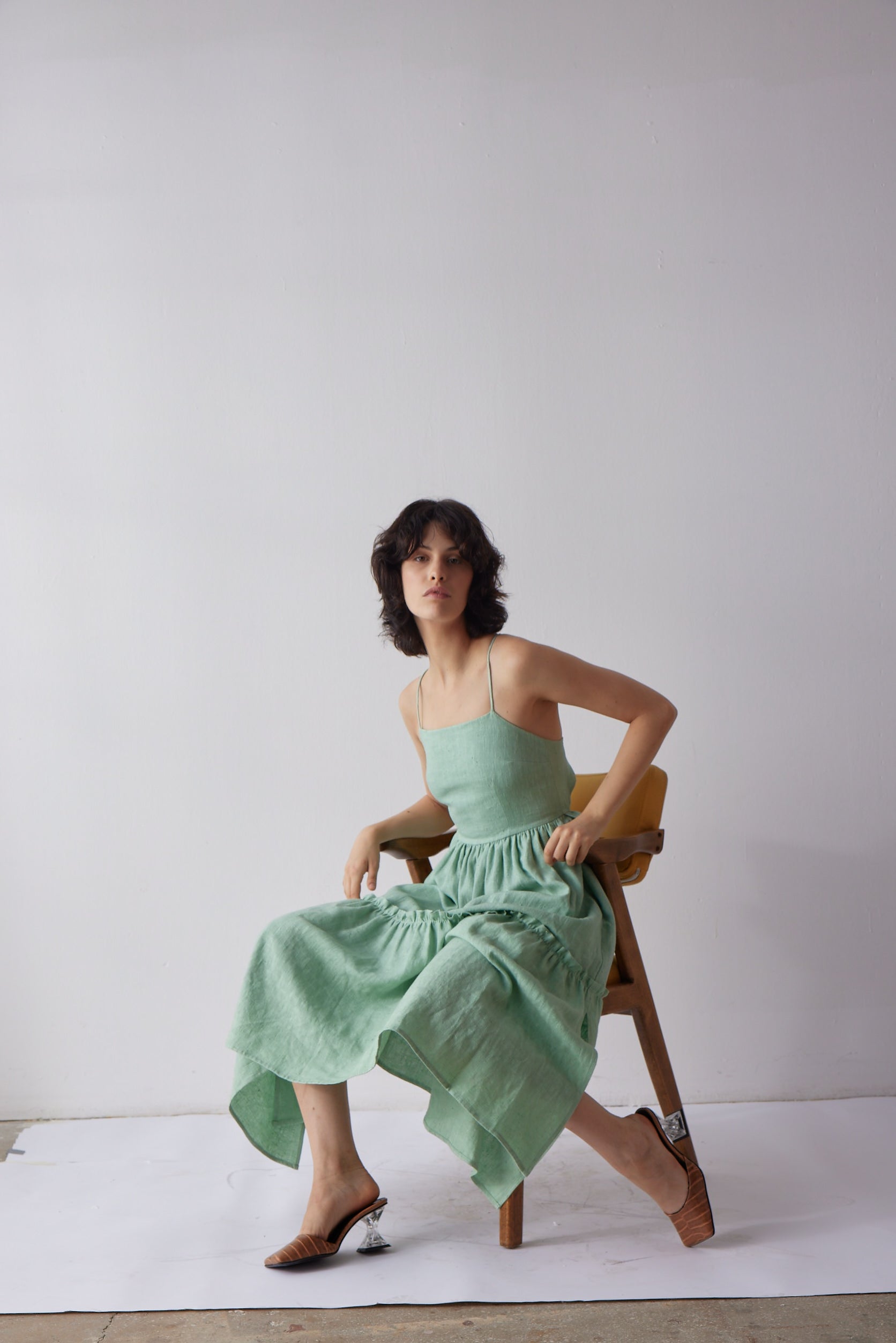 Holly Dress - Green on model in chair