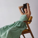 Holly Dress - Green imaged on model in chair