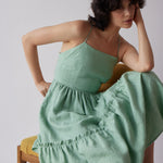 Holly Dress - Green model sitting down 