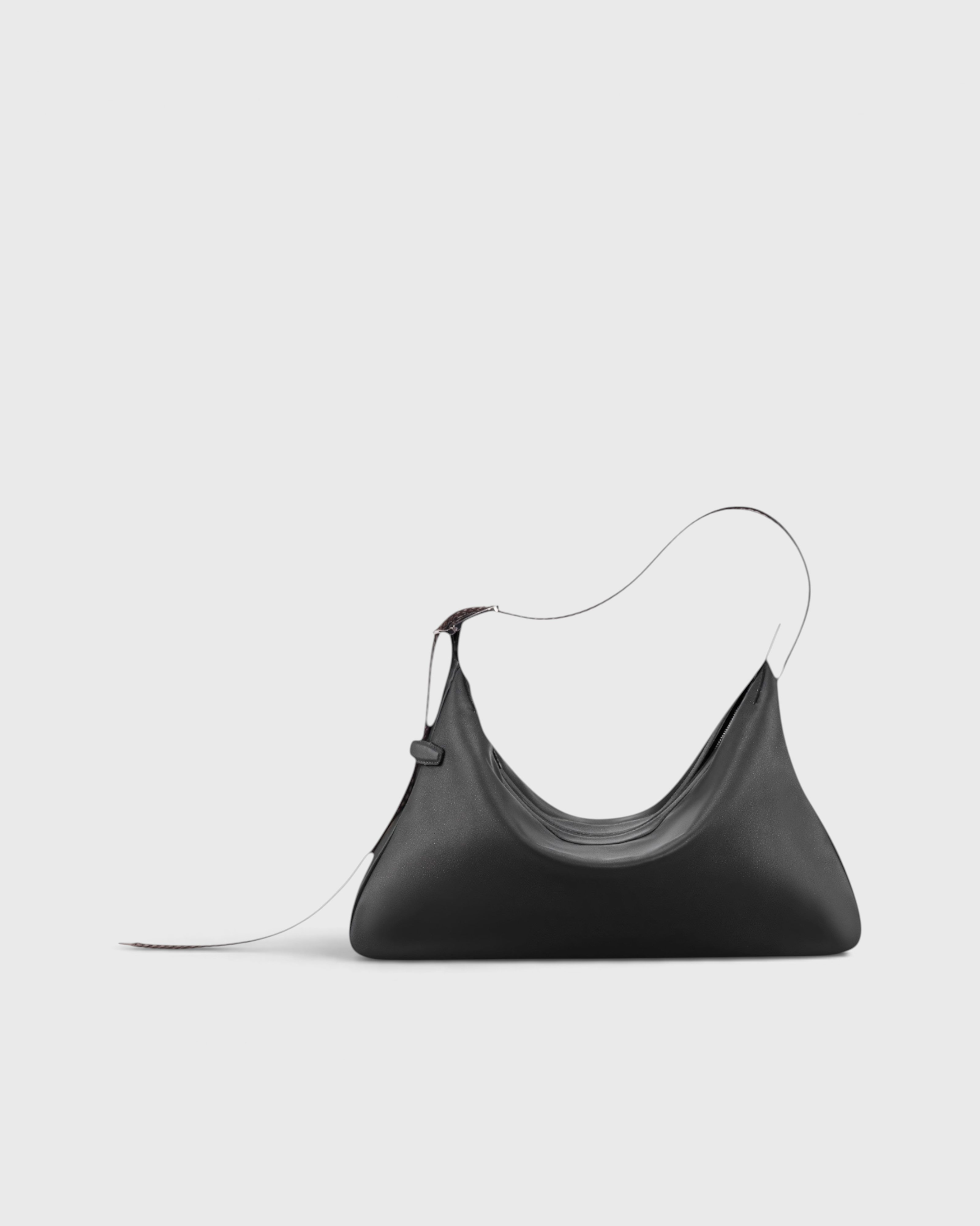 JONES + CO Rider M Elche black leather bag with a unique skateboard rink silhouette and hand-braided strap.