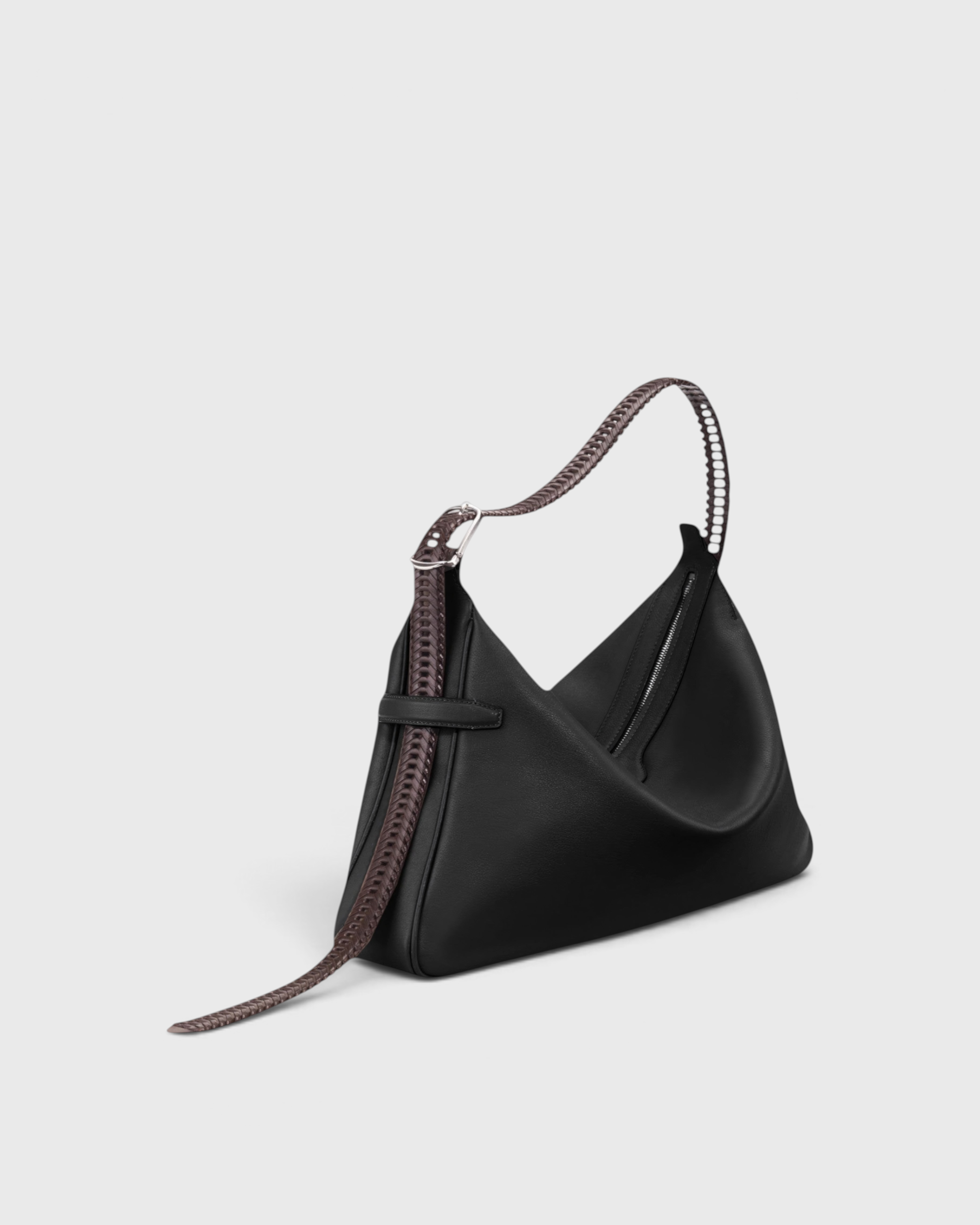 JONES + CO Rider M Elche black leather bag with a unique hand-braided strap and architectural silhouette.