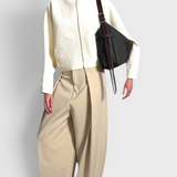 JONES + CO Rider M Elche black leather bag with a hand-braided strap worn as a shoulder bag by a model