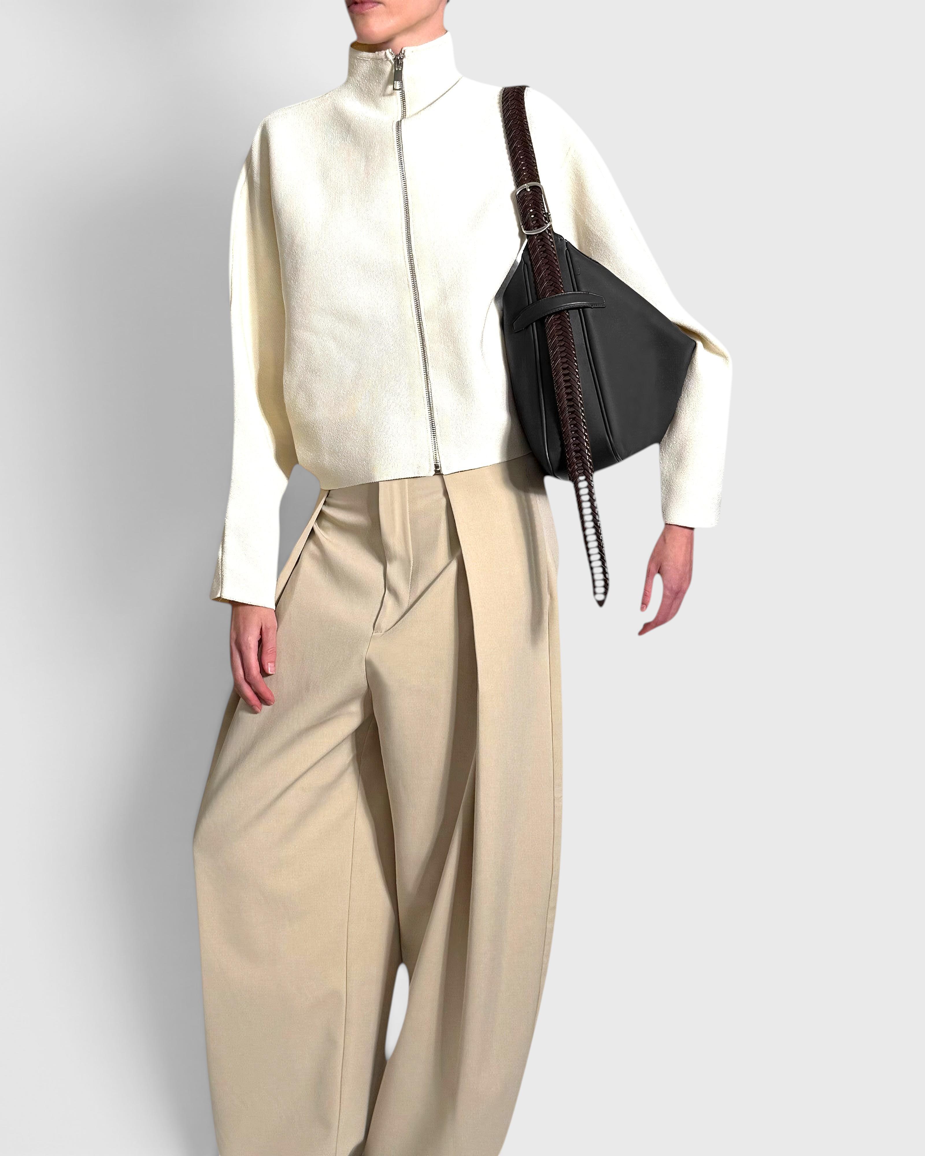 JONES + CO Rider M Elche black leather bag with a hand-braided strap worn as a shoulder bag by a model