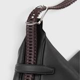 JONES + CO Rider M Elche black leather bag with a unique hand-braided dark brown strap and silver hardware detail.