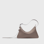 JONES + CO Rider S taupe leather bag with a unique skateboard rink shape and adjustable belt-style shoulder strap.