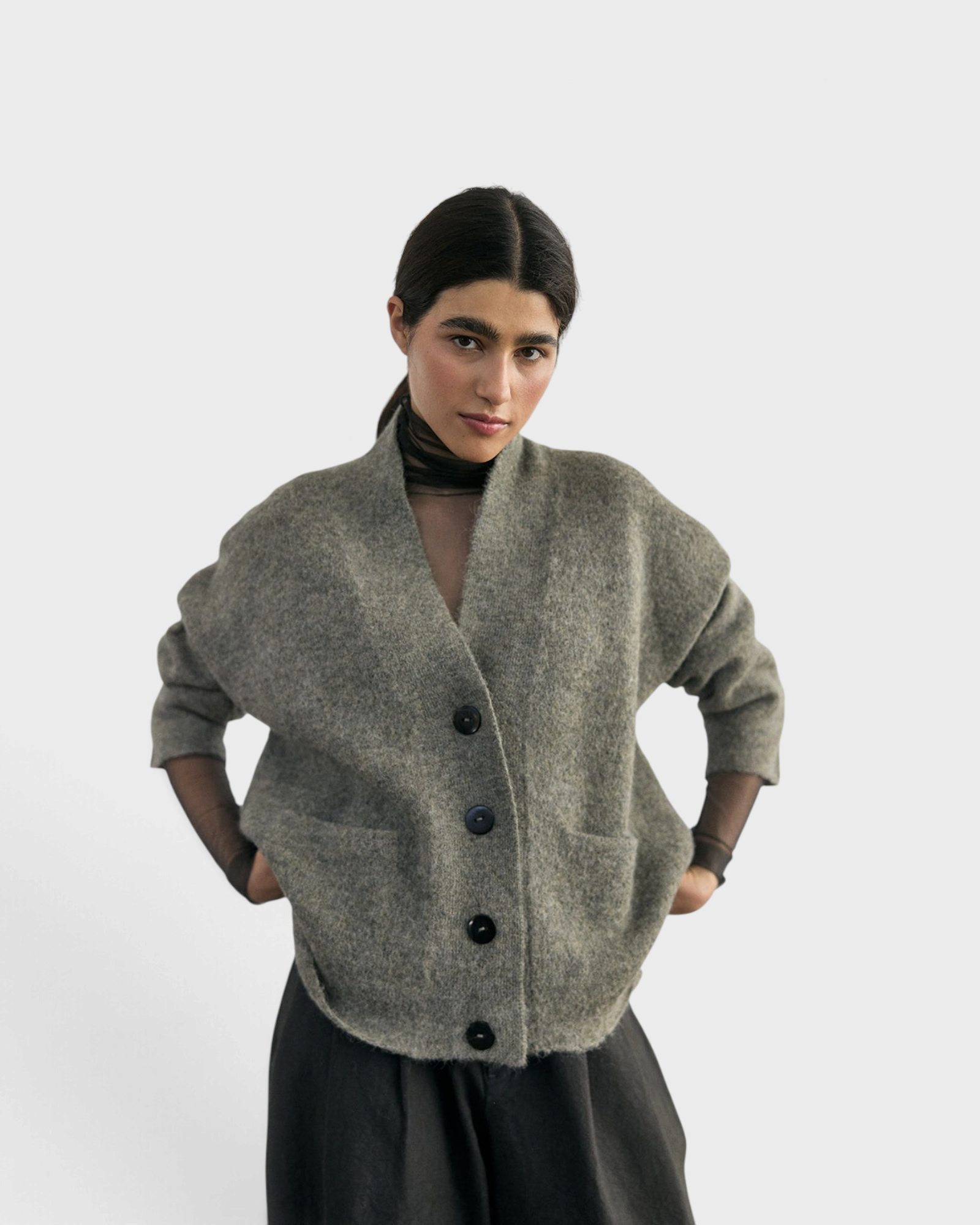 SISA Felted Alpaca Cardigan in Moss, front view with hands in the patch pockets
