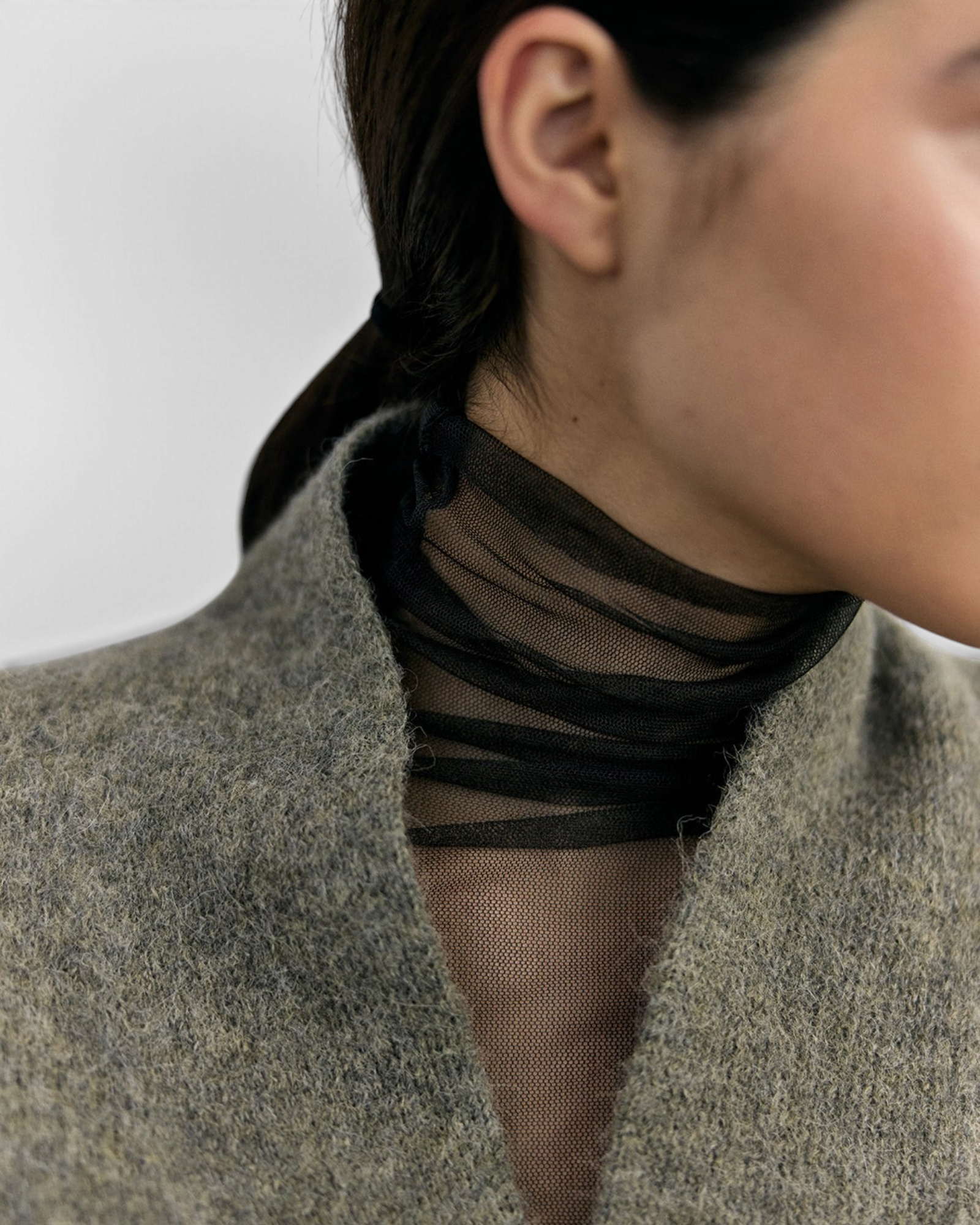 SISA Felted Alpaca Cardigan in Moss, close detail of the V-neckline and horn buttons