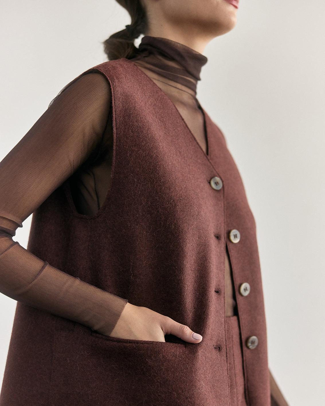SISA Silk Tulle Beatle in Eggplant, layered under a felted vest, side detail of the sleeve
