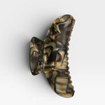 Tortoiseshell patterned hair clip on a white background