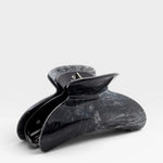 Black marble-patterned hair clip on a white background
