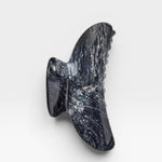 Black marble wall sculpture on a white background