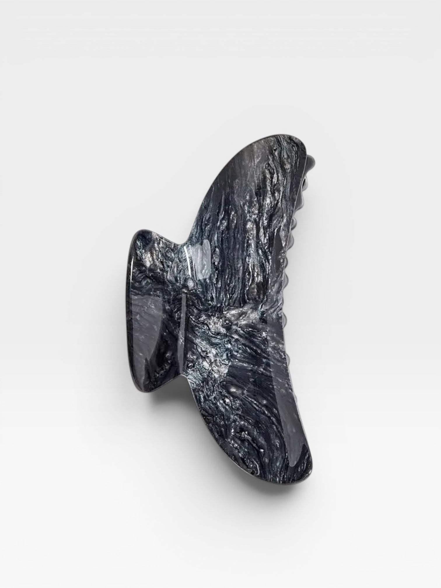 Black marble wall sculpture on a white background