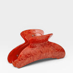 Red hair clip on a white background