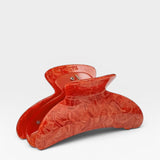 Red hair clip on a white background