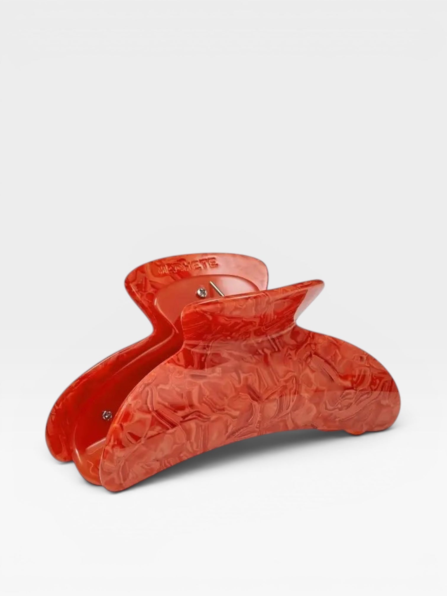 Red hair clip on a white background