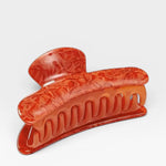 Red hair clip on a white background