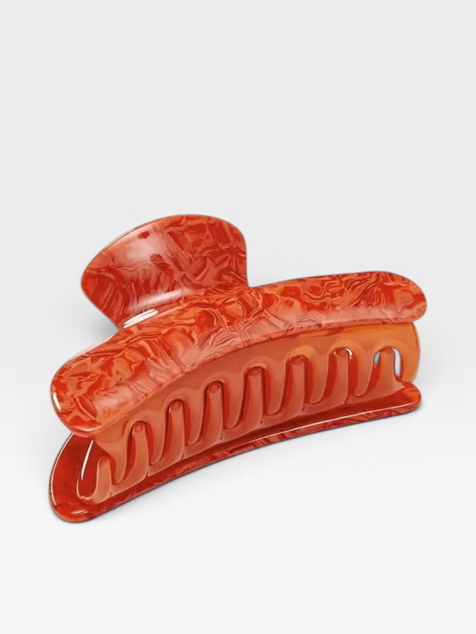 Red hair clip on a white background