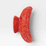 Red clip on a white background