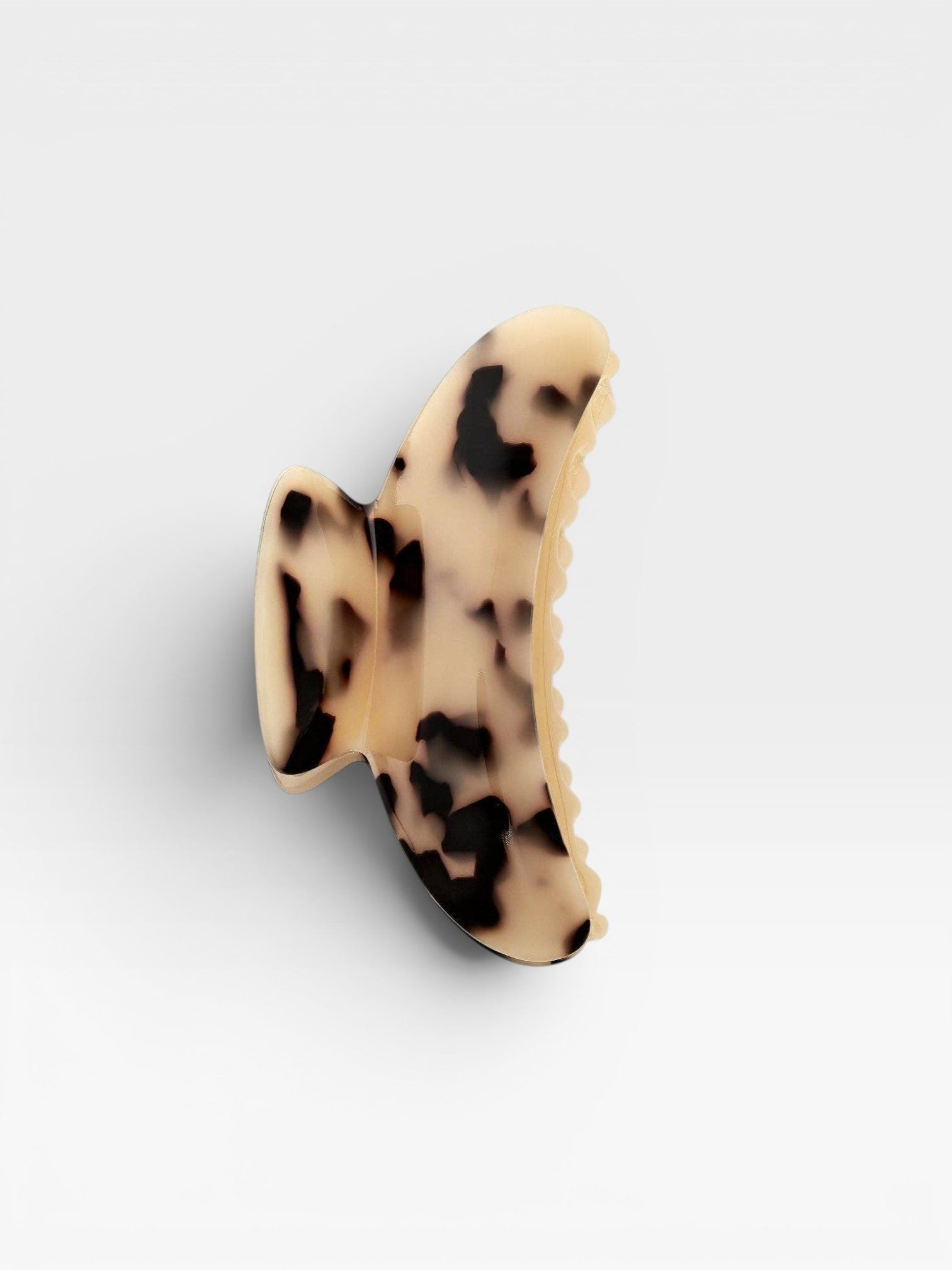 Claw clip with a tortoiseshell pattern on a white background