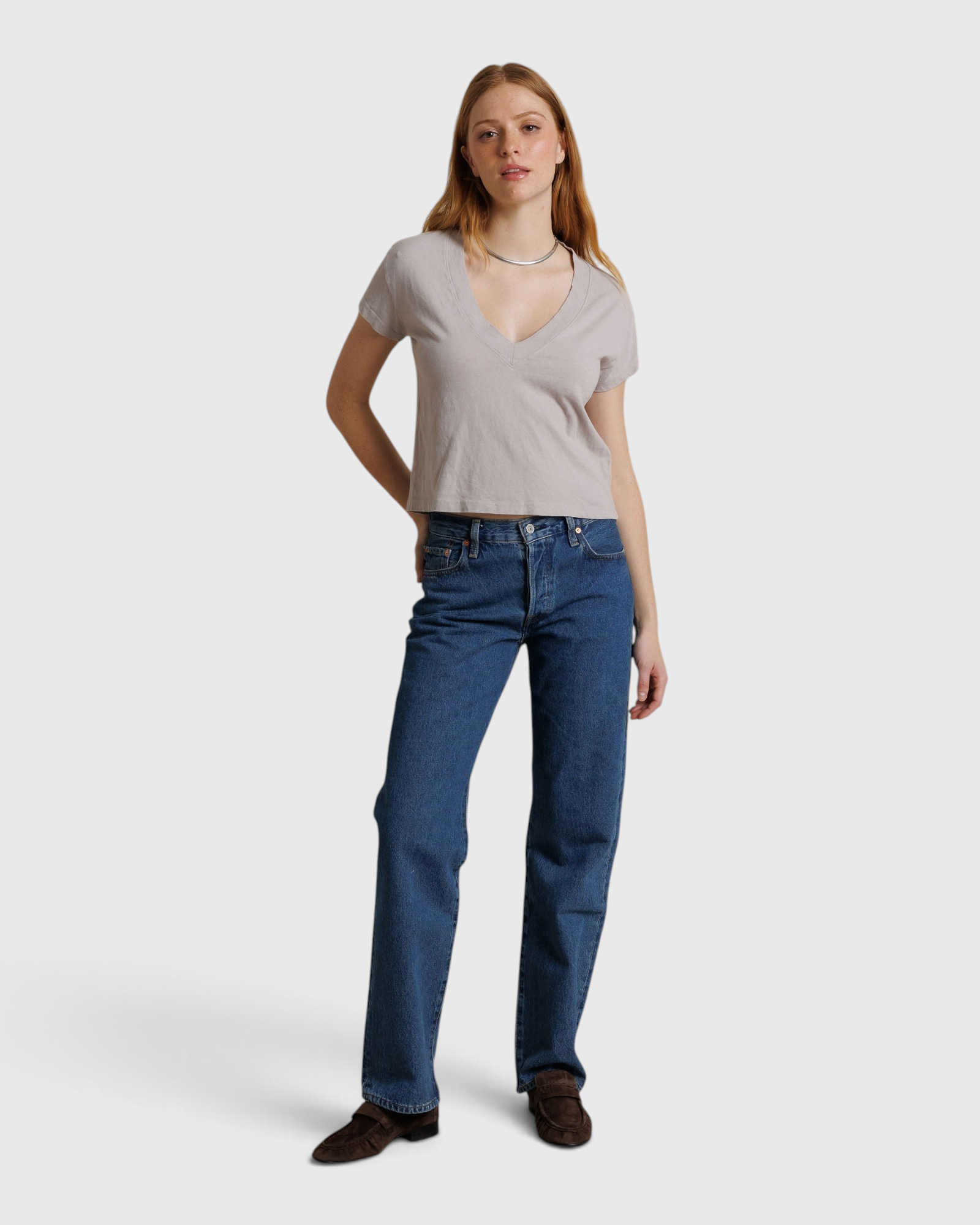 JONES + CO Alanis V-neck tee in cloud gray recycled cotton worn by a model with blue jeans against a neutral backdrop