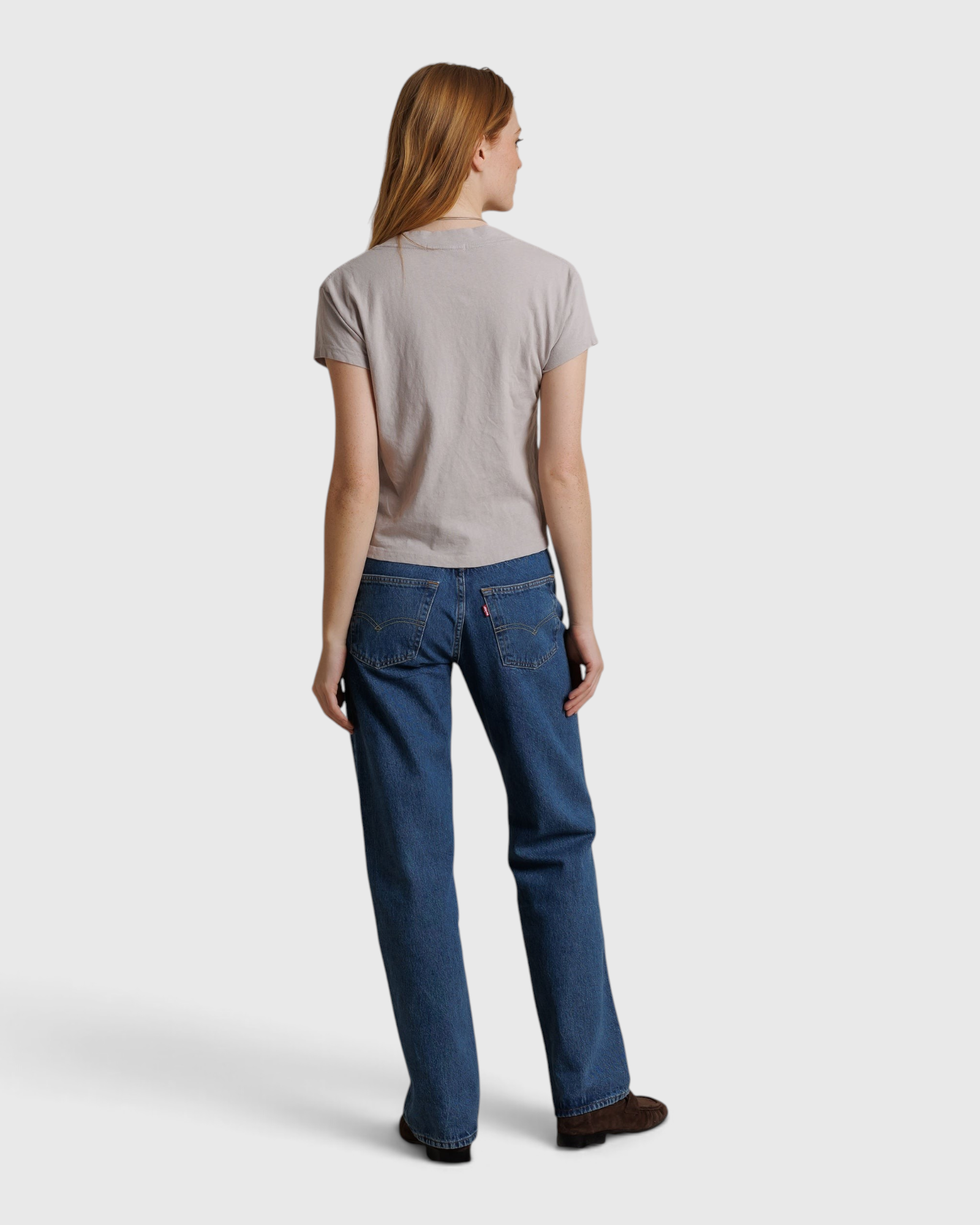 JONES + CO Alanis V Neck tee in cloud gray recycled cotton, shown from the back on a model with blue jeans.