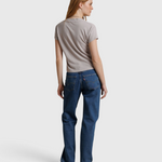 JONES + CO Alanis V Neck tee in cloud gray recycled cotton worn by a model with blue jeans, back view