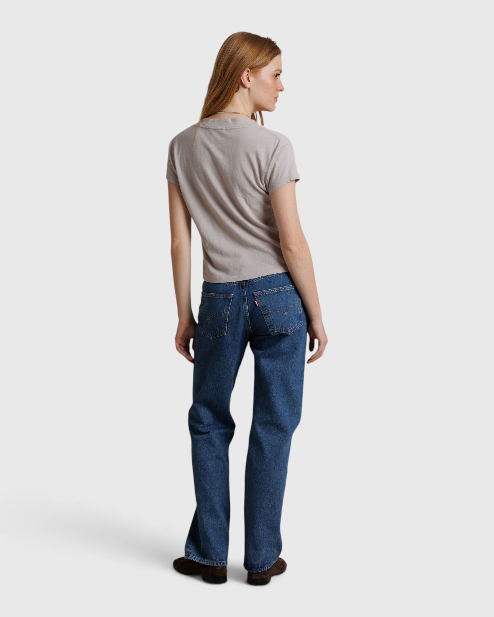 JONES + CO Alanis V Neck tee in cloud gray recycled cotton worn by a model with blue jeans, back view