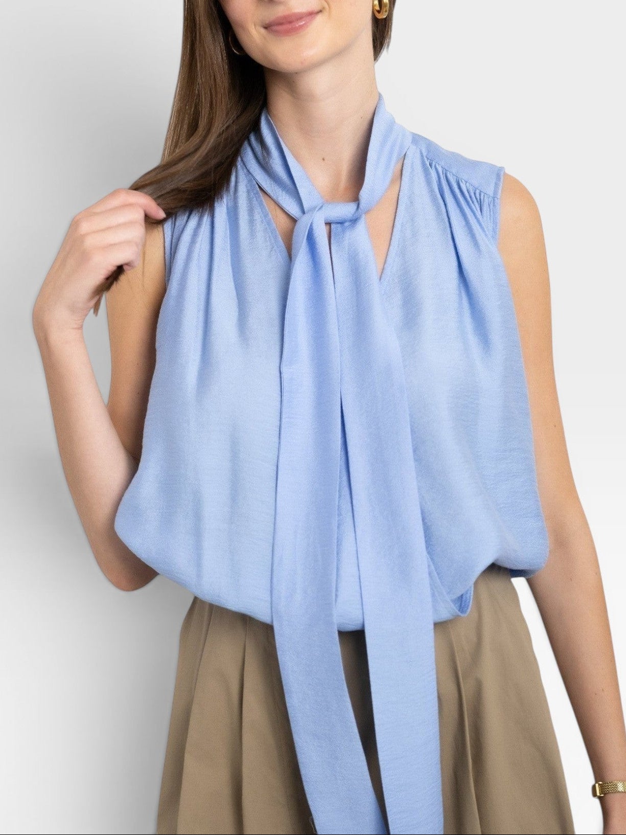 JONES + CO Amara blue sleeveless blouse with a pussy bow tie neck and gathered detail.