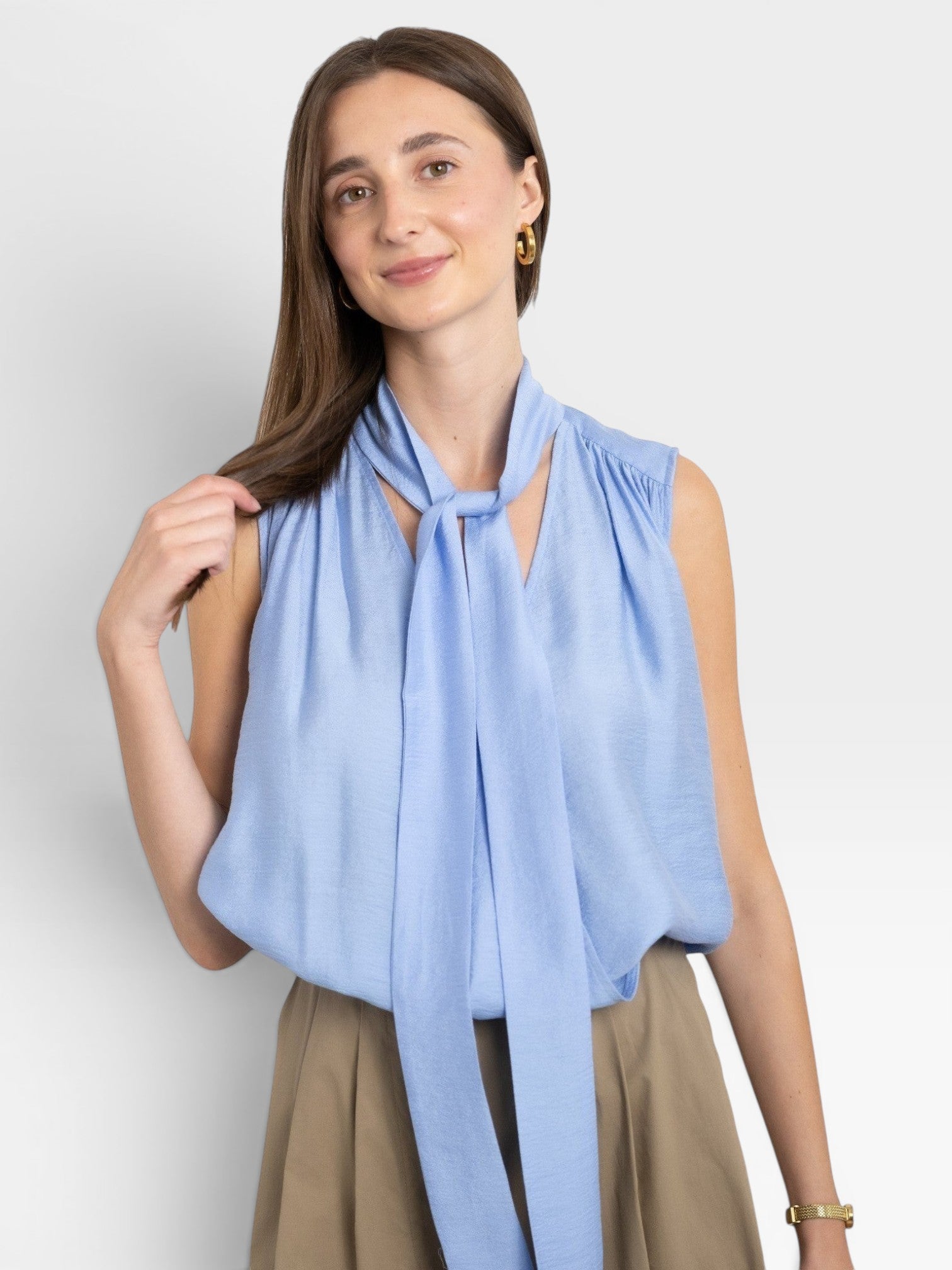 JONES + CO Amara blue sleeveless blouse with a pussy bow tie neck and gathered detail.
