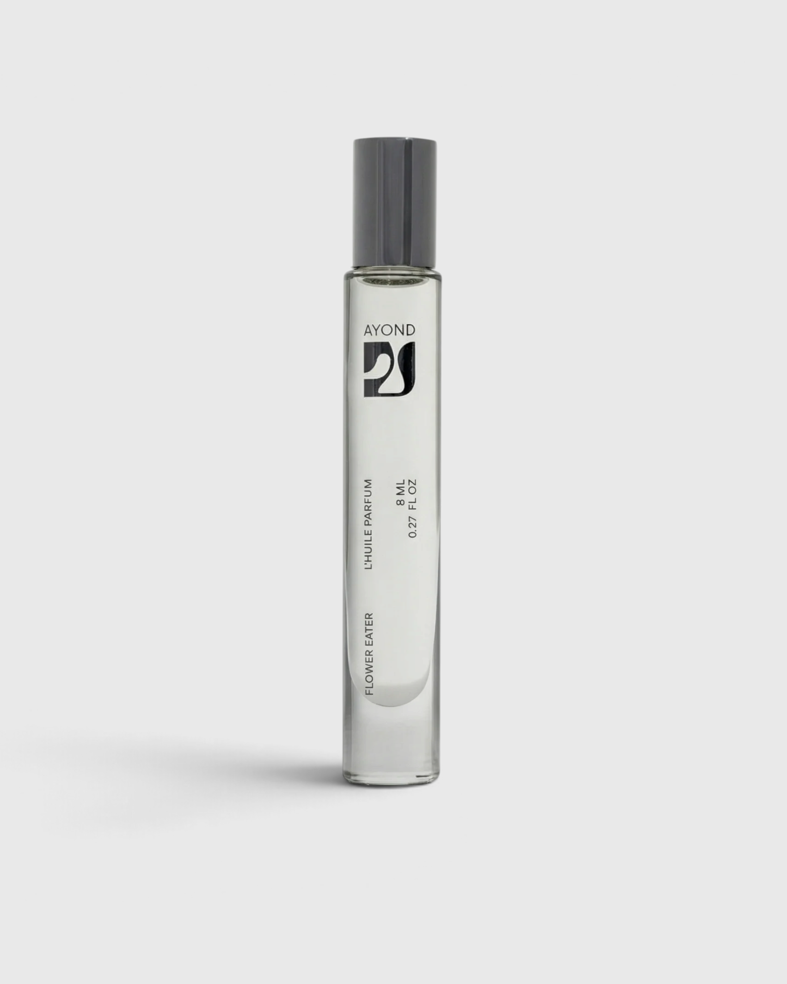 JONES + CO Flower Eater natural perfume oil roll-on in a sleek clear glass bottle with a grey cap.