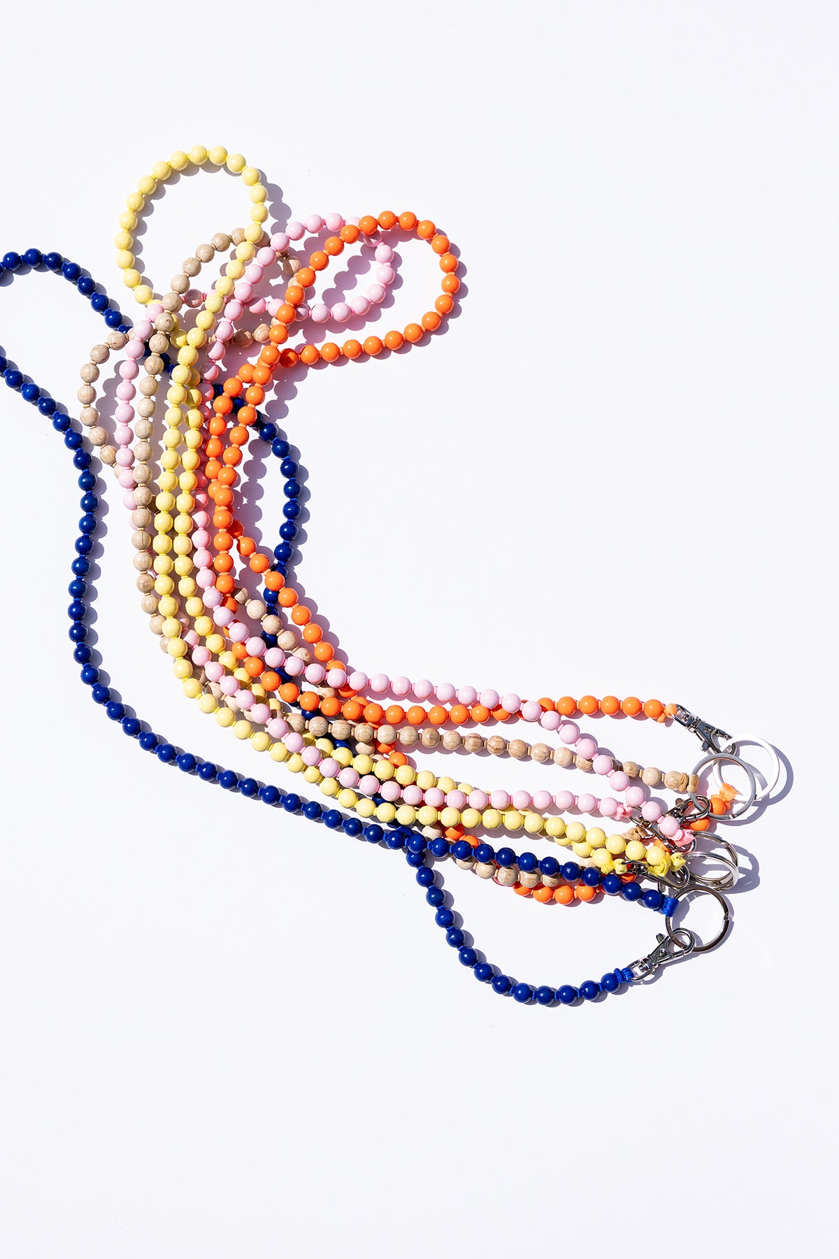 Set of colorful beaded lanyards on a white background