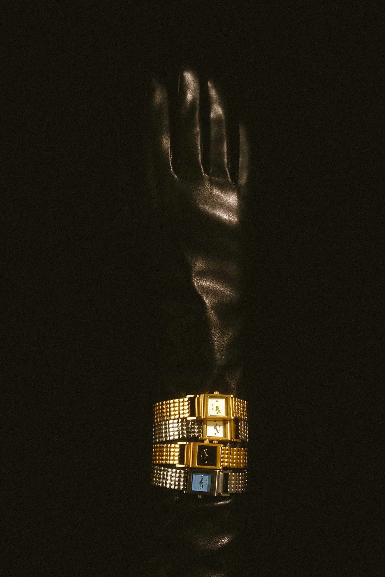 Gold ring with black accents on a reflective black surface