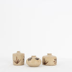 Three Bettina Chow olive leaf bud vases in natural clay with hand-painted leaf and flower motifs