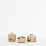 Three Bettina Chow olive leaf bud vases in natural clay with hand-painted leaf and flower motifs