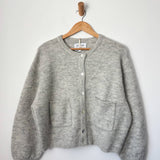 Amélie Alpaca Cardigan - Light Grey hanging on hanger