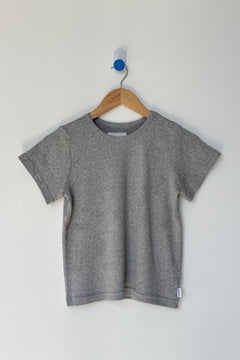 Gray t-shirt on a wooden hanger against a white background