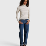 JONES + CO Cindy long sleeve turtleneck top in natural stripe worn with blue jeans by a model