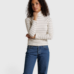 JONES + CO Cindy long sleeve turtleneck top in natural stripe worn by a model with blue jeans
