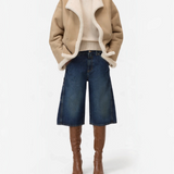 JONES + CO Wylie dark blue denim Bermuda shorts with carpenter details and silver studs, worn with boots.