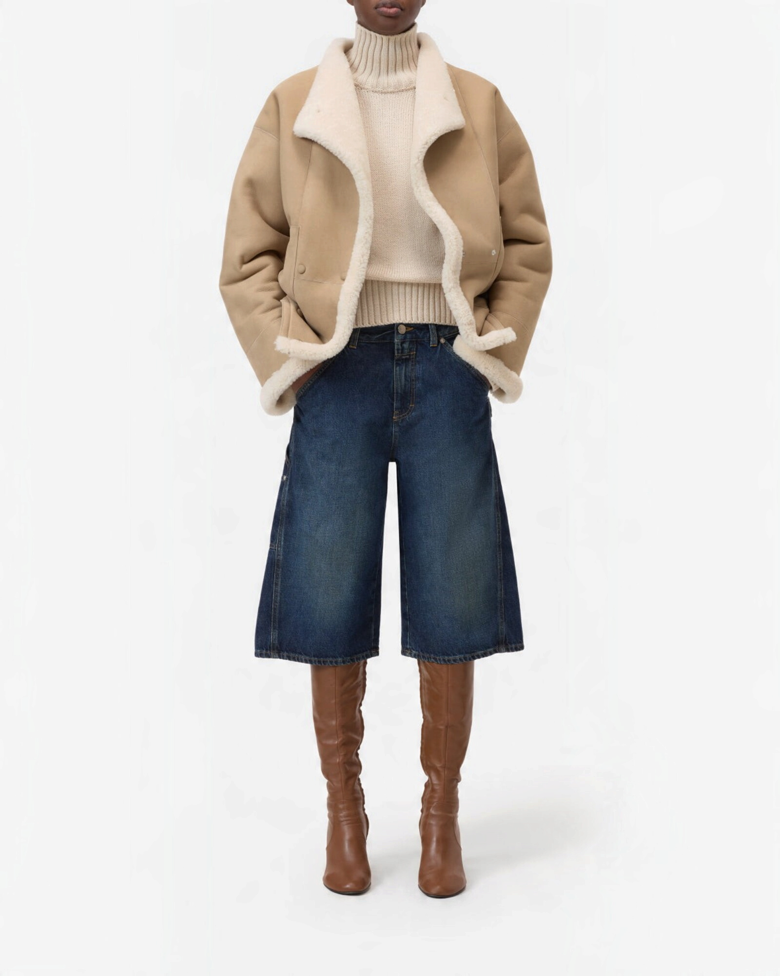 JONES + CO Wylie dark blue denim Bermuda shorts with carpenter details and silver studs, worn with boots.