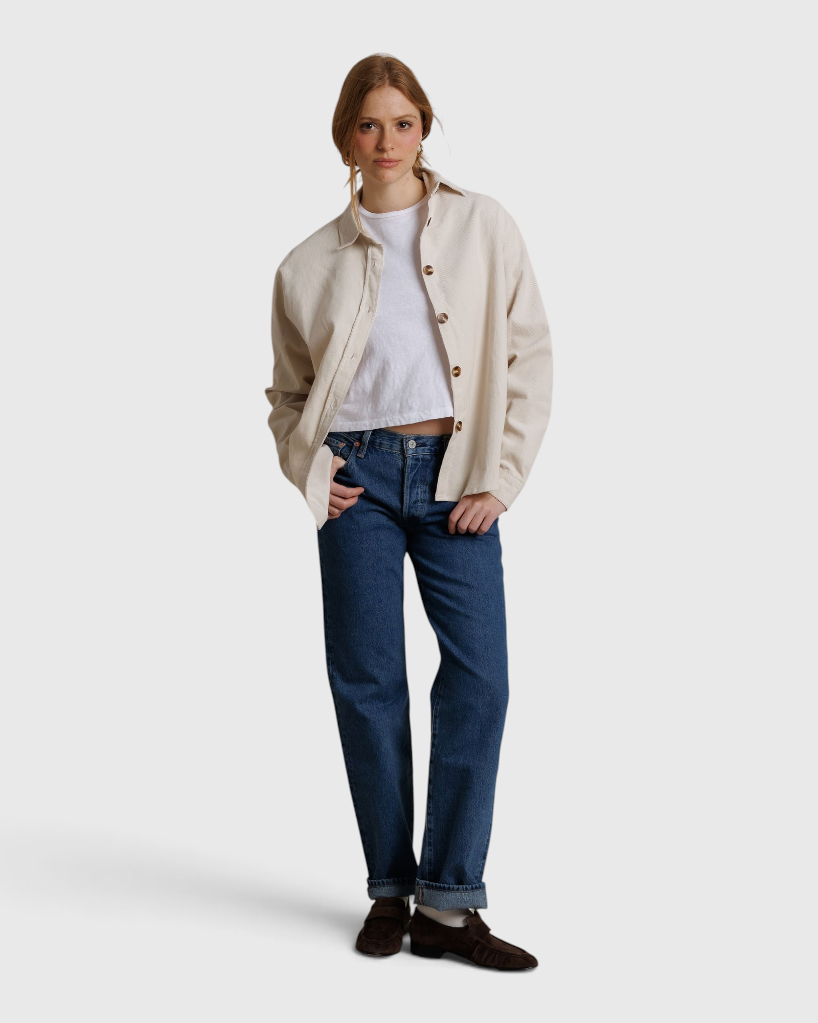JONES + CO James button-up shirt in whitecap gray worn over a white tee and blue jeans by a woman in a studio.