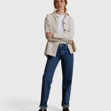 Model wearing a JONES + CO whitecap gray James button-up shirt over a white tee and blue jeans