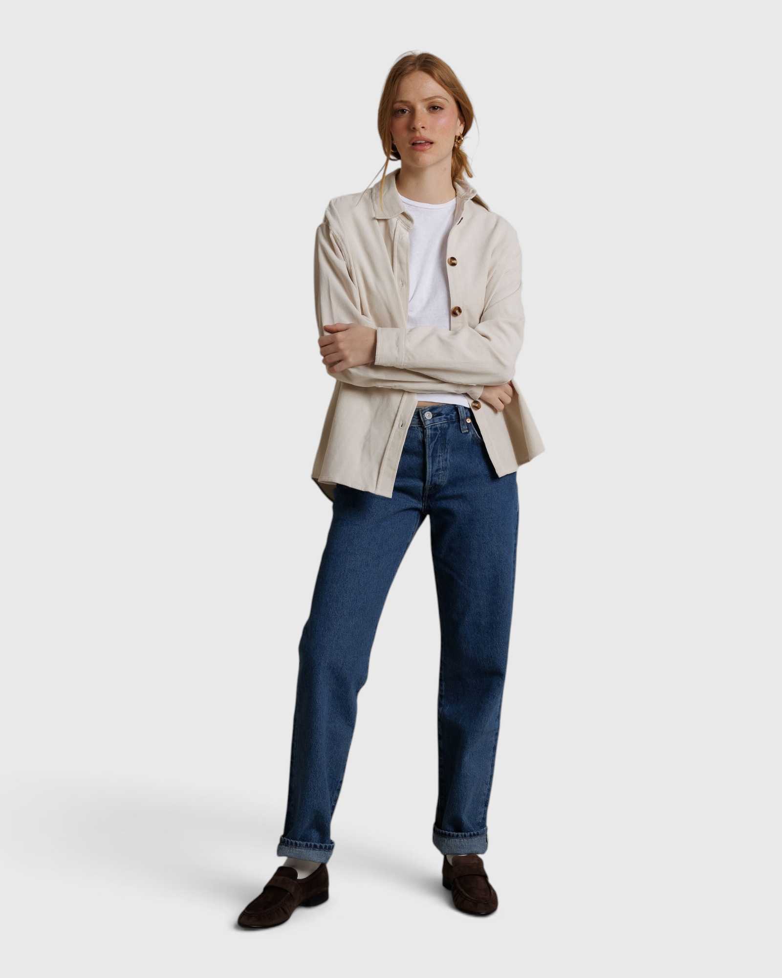 Model wearing a JONES + CO whitecap gray James button-up shirt over a white tee and blue jeans